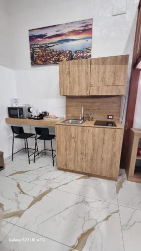 a kitchen with a sink and a table with chairs at San Ciro's Suite in Portici