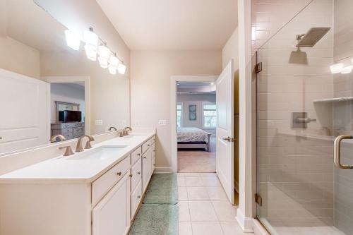 a bathroom with two sinks and a shower at Coastal Club --- 33718 Freeport Dr. in Lewes