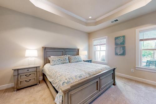 a bedroom with a bed and a nightstand and a window at Coastal Club --- 33718 Freeport Dr. in Lewes