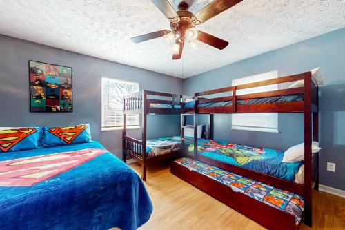 a bedroom with two bunk beds and a ceiling fan at Hideaway Haven in Jones Cove