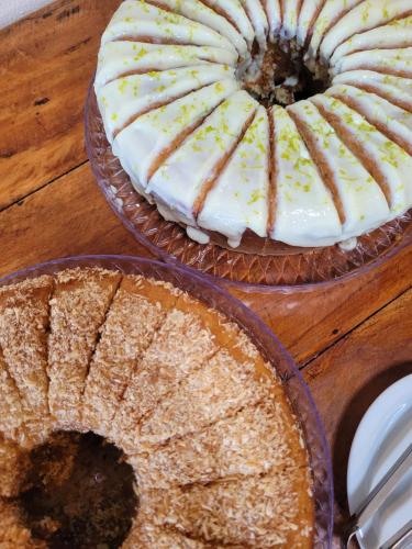 two pies sitting on top of a wooden table at Pousada Estrela do Mar in Maresias