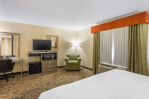a hotel room with a bed and a television at Best Western Danville Inn in Danville
