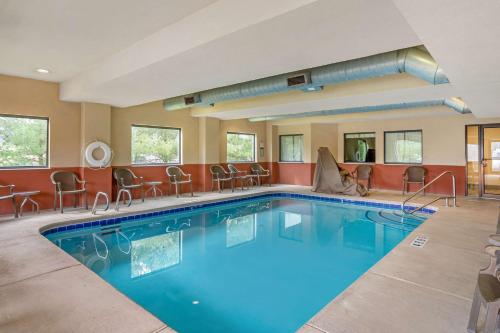 a pool at a hotel with chairs and tables at Best Western Danville Inn in Danville