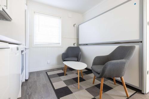 two chairs and a table in a room with a chalkboard at Sure Hotel by Best Western Vilsta Sporthotell in Eskilstuna