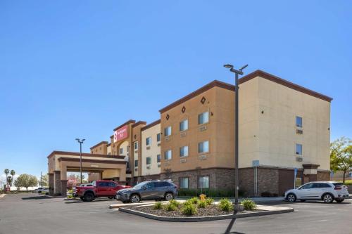 a building with cars parked in a parking lot at Best Western Plus Taft Inn in Taft