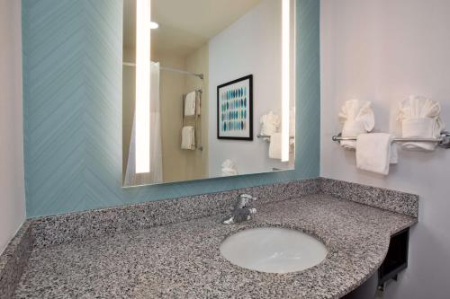 a bathroom with a sink and a mirror at Hilton Garden Inn Benton Harbor in Benton Harbor