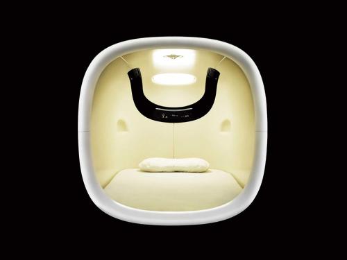 a room with a chair with a face on it at 9h nine hours Shinagawa station for men in Tokyo