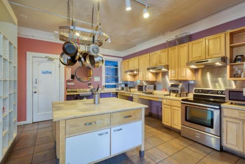 a large kitchen with wooden cabinets and appliances at HI San Francisco Downtown Hostel in San Francisco