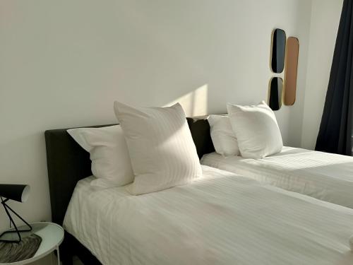 two beds with white pillows sitting next to each other at Disneyland-PARIS Sunshine - 6pers - Terrasse - vue sur Parc - 2Parkings in Chessy