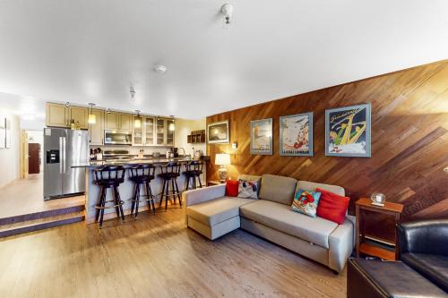 a living room with a couch and a kitchen at North #409 in Anchorage