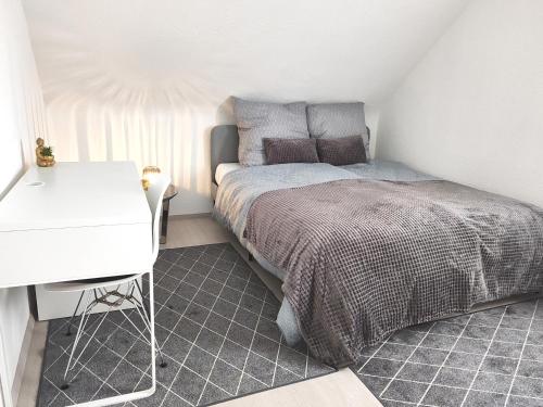 a small bedroom with a bed and a desk at Top Wohnung in Mainz-Kostheim in Mainz-Kostheim