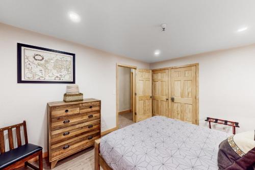 - une chambre avec un lit et une commode en bois dans l'établissement North #409, à Anchorage