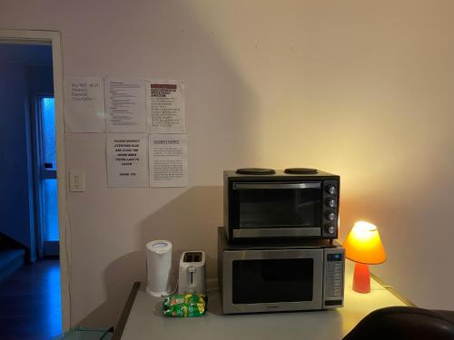 a microwave sitting on top of a table with a lamp at Bush , birds and relaxing moments in Auckland