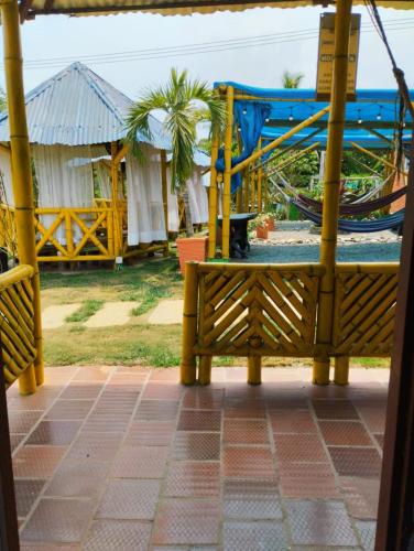 a wooden bench sitting on top of a beach at La Rivera Playa Palomino in Palomino