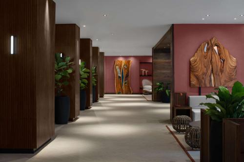 a hallway with potted plants in a lobby at ROK Hotel Kingston Tapestry Collection By Hilton in Kingston