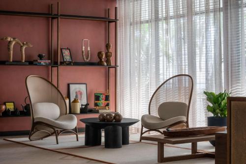 a living room with two chairs and a table at ROK Hotel Kingston Tapestry Collection By Hilton in Kingston