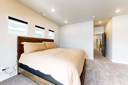 a bedroom with a large bed and two windows at Purple Flower in Park City