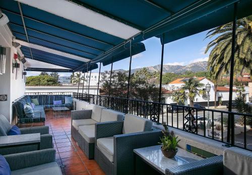 a balcony with couches and a view of the mountains at Hotel Virginia Santa Barbara, Tapestry Collection by Hilton in Santa Barbara