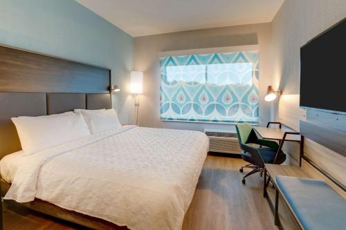 a hotel room with a bed and a window at Tru By Hilton Smithfield I-95 in Smithfield