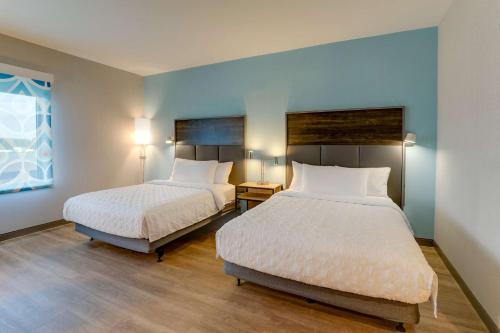 two beds in a room with blue walls at Tru By Hilton Smithfield I-95 in Smithfield