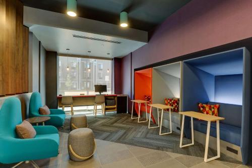 a waiting room with chairs and tables and a counter at Tru By Hilton Smithfield I-95 in Smithfield