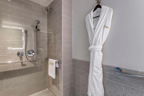 a shower with a white shower curtain in a bathroom at The Draper New York, Tapestry Collection by Hilton in New York