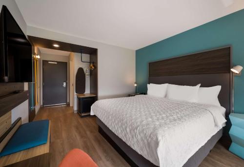 a hotel room with a bed and a television at Tru By Hilton Novi Detroit in Novi