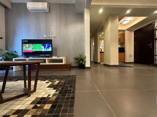 a lobby with a tv in the middle of a building at Mirage residence resort in Cairo