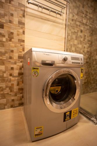 a washing machine is sitting in a room at Mirage residence resort in Cairo