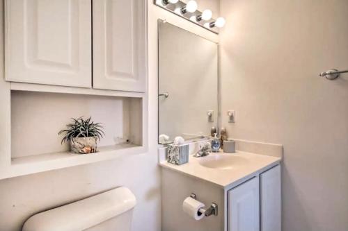 a white bathroom with a sink and a mirror at Bethany Bay - 37434 Pettinaro Dr #4805 in Ocean View