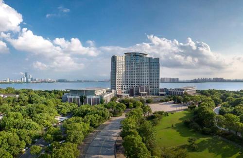 an aerial view of a tall building next to the water at Kempinski Hotel Suzhou in Suzhou