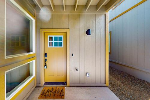 a hallway with a yellow door in a building at The Pines in Flagstaff