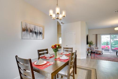 a dining room and living room with a table and chairs at Mankato Getaway with Game Room and Salt Water Hot Tub! in Mankato