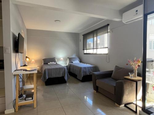 a living room with two beds and a couch at Premium Apartment Rosario - Joan Miró in Rosario