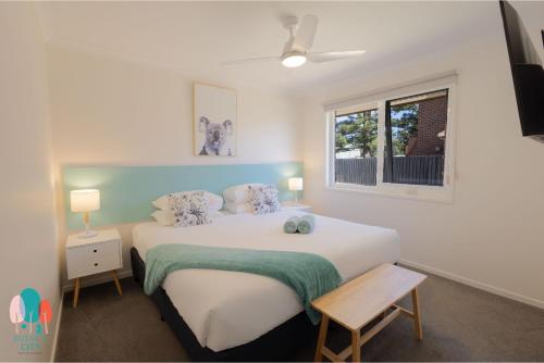a bedroom with a large bed and a window at Botanic City Apartments in Warrnambool