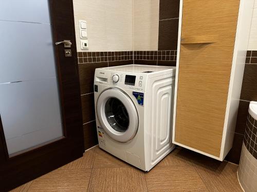 a washer and dryer in a small room at Apartment Karla Capka Street in Karlovy Vary