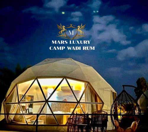 a large dome tent with the words mars luxury camp waldrun at MARS LUXURY CAMP WADi RUM in Wadi Rum