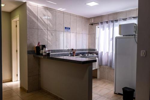 a kitchen with a sink and a refrigerator at Apartamento próximo centro in Lages