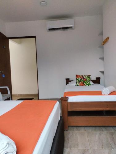 a hotel room with two beds and a window at La Rivera Playa Palomino in Palomino