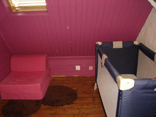 a purple room with a couch and a chair at Gîte de la Chapelle in Trédarzec
