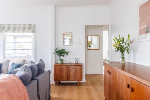 a living room with a couch and a table at Sussex Beach House in Sussex inlet