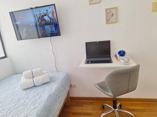 a bedroom with a laptop computer on a desk at Habitación baño Compartido La Paz 2 in Lima