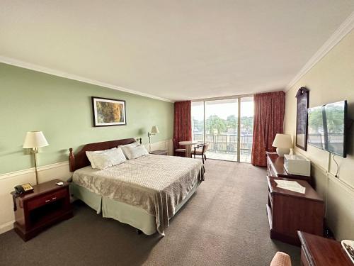 a hotel room with a bed and a window at Hotel Chateaubleau in Miami