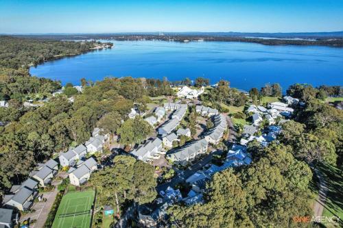 an aerial view of a resort with a lake at Stay At Raffertys Resort in Swansea