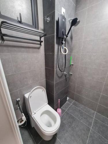 a small bathroom with a toilet and a shower at Tiny Studio Suite Near Gleneagles 10 mins to KLCC in Kuala Lumpur