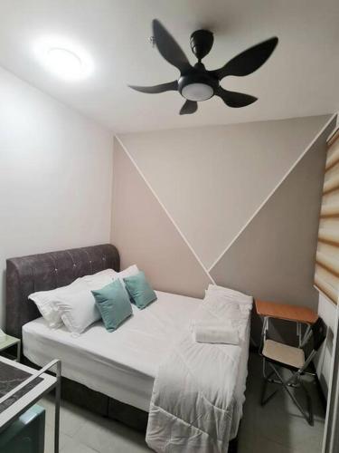 a bedroom with a bed with a ceiling fan at Tiny Studio Suite Near Gleneagles 10 mins to KLCC in Kuala Lumpur