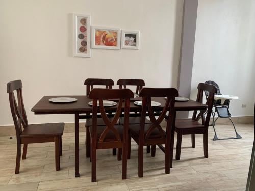 a wooden dining room table and chairs in a room at Casa G&V x 8 personas in Flores