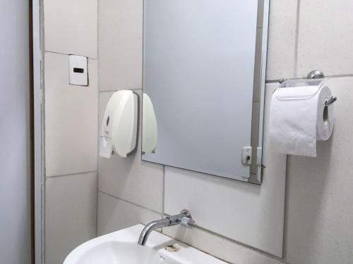 a bathroom with a sink and a mirror at Hotel Music and Sports in Sao Paulo