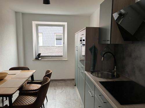 a kitchen with a table and a dining room at International 7 in Bad Harzburg
