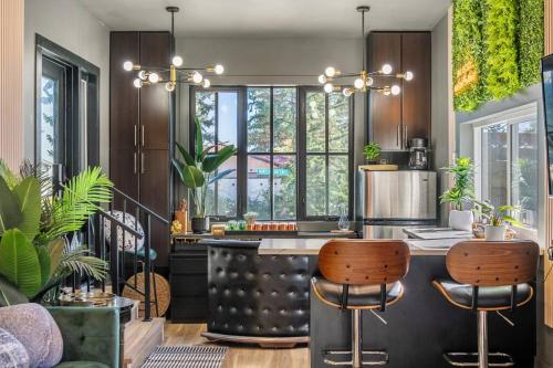 a kitchen with a counter with stools in it at Dome House YYC, Iconic, Luxury, Backyard Oasis in Calgary